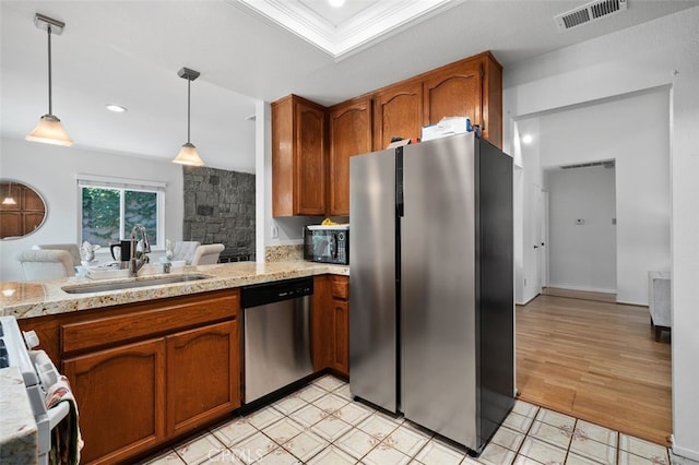 566 Elkhorn Dr, Duarte, CA 91010 - kitchen with stainless steel appliances, a sink, brown cabinets, pendant lighting, and recessed lighting