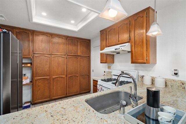 566 Elkhorn Dr, Duarte, CA 91010 - kitchen with under cabinet range hood, freestanding refrigerator, white gas stove, brown cabinets, and recessed lighting