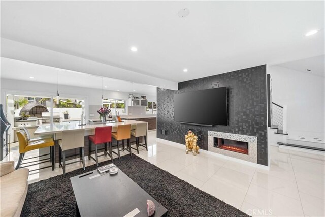 20191 Imperial Cove Ln, Huntington Beach, CA 92646 - living room featuring an accent wall, recessed lighting, a large fireplace, baseboards, and light tile patterned flooring