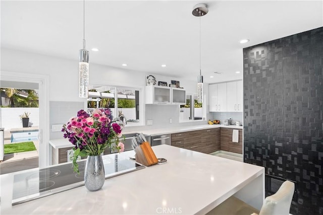 20191 Imperial Cove Ln, Huntington Beach, CA 92646 - kitchen with light countertops, white cabinets, modern cabinets, hanging light fixtures, and recessed lighting