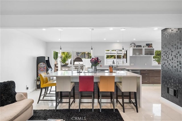 20191 Imperial Cove Ln, Huntington Beach, CA 92646 - kitchen featuring a kitchen bar, light countertops, a sink, an island with sink, and recessed lighting