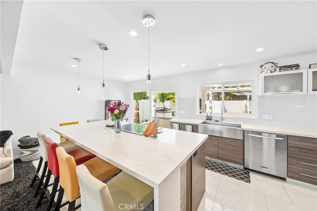 20191 Imperial Cove Ln, Huntington Beach, CA 92646 - kitchen featuring stainless steel dishwasher, a sink, a kitchen breakfast bar, light countertops, and recessed lighting