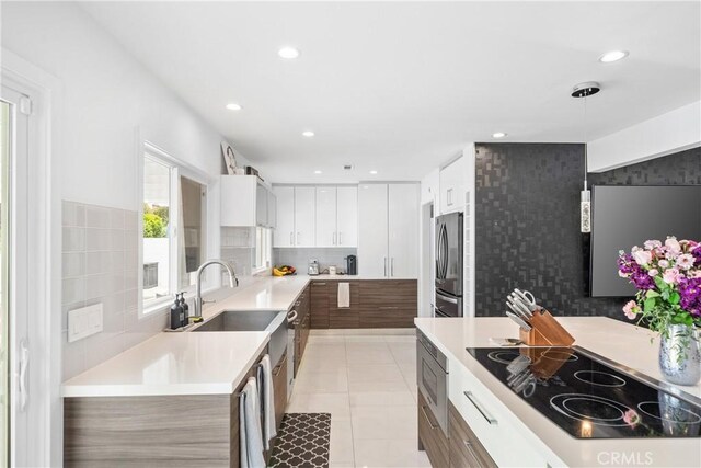 20191 Imperial Cove Ln, Huntington Beach, CA 92646 - kitchen featuring stainless steel appliances, a sink, light countertops, white cabinets, and recessed lighting