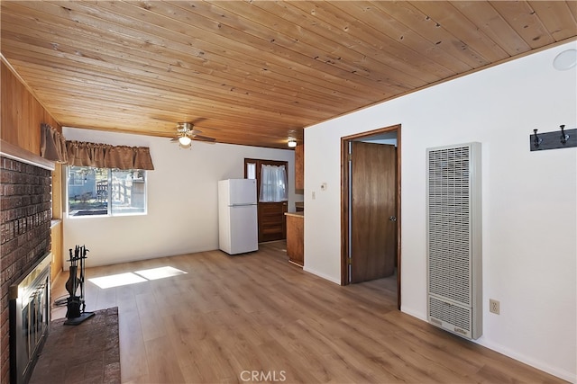 unfurnished living room featuring a heating unit, wooden ceiling, a brick fireplace, wood finished floors, and a ceiling fan