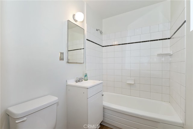 bathroom featuring toilet, shower / bathtub combination, and vanity