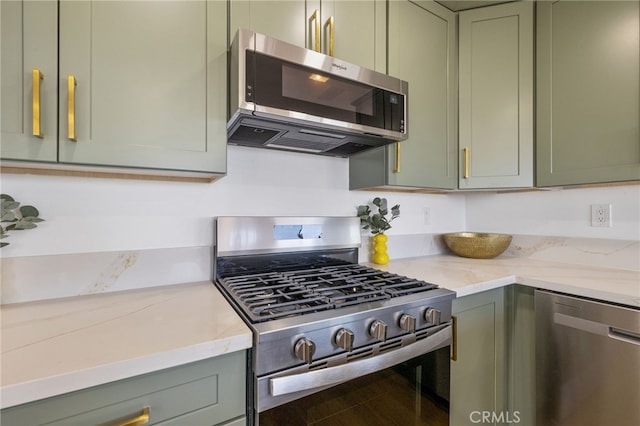 21408 Apollo Way, Desert Hot Springs, CA 92241 - kitchen featuring appliances with stainless steel finishes, green cabinets, and light stone countertops