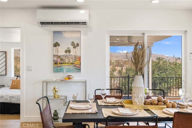 21408 Apollo Way, Desert Hot Springs, CA 92241 - dining room featuring a wall mounted AC, recessed lighting, and wood finished floors