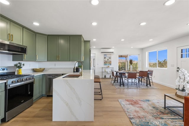 21408 Apollo Way, Desert Hot Springs, CA 92241 - kitchen featuring green cabinets, appliances with stainless steel finishes, a sink, a wall mounted air conditioner, and recessed lighting