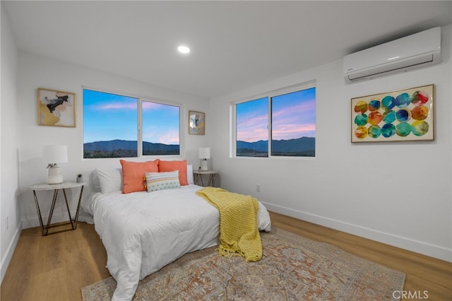 21408 Apollo Way, Desert Hot Springs, CA 92241 - bedroom featuring a wall mounted AC, baseboards, wood finished floors, and recessed lighting
