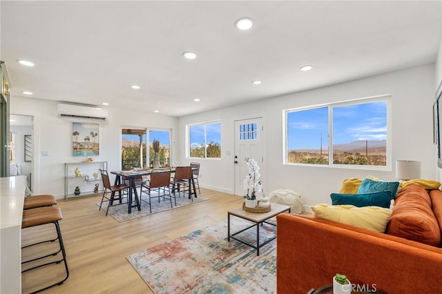 21408 Apollo Way, Desert Hot Springs, CA 92241 - living room featuring a wall mounted AC, recessed lighting, light wood-style flooring, and baseboards