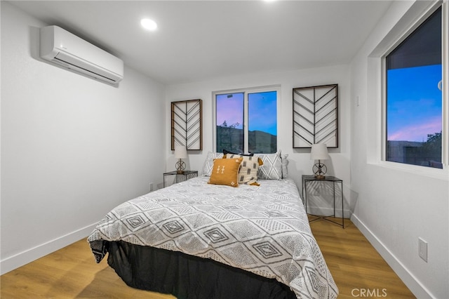 21408 Apollo Way, Desert Hot Springs, CA 92241 - bedroom featuring a wall unit AC, wood finished floors, baseboards, and recessed lighting