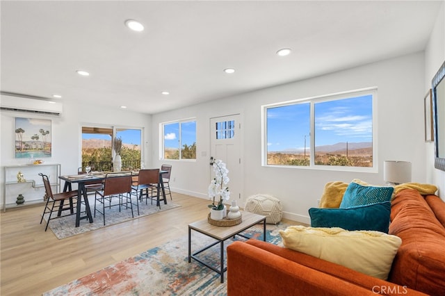 21408 Apollo Way, Desert Hot Springs, CA 92241 - living area featuring a wall mounted AC, recessed lighting, light wood-type flooring, and baseboards