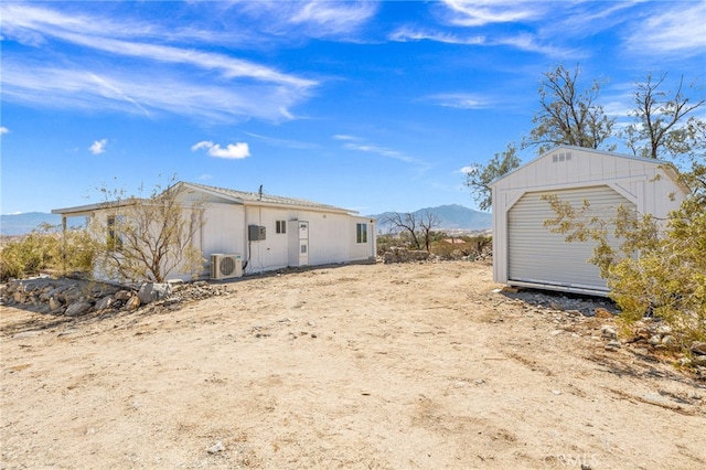 21408 Apollo Way, Desert Hot Springs, CA 92241 - rear view of property with a mountain view, ac unit, and an outdoor structure