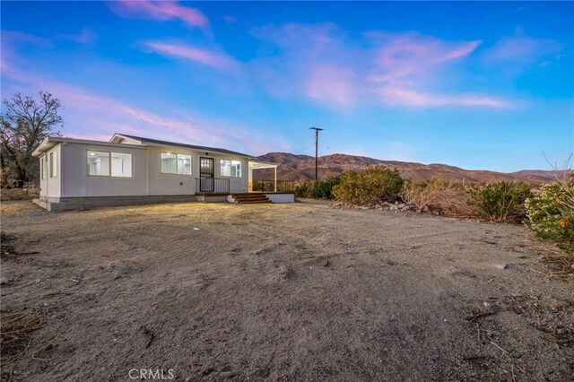 21408 Apollo Way, Desert Hot Springs, CA 92241 - back of property at dusk with a mountain view