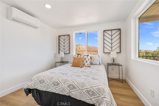 21408 Apollo Way, Desert Hot Springs, CA 92241 - bedroom with a wall mounted AC, baseboards, wood finished floors, and recessed lighting