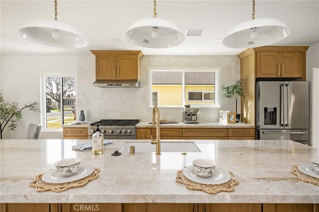 1909 Montair Ave, Long Beach, CA 90815 - kitchen featuring stainless steel appliances, light stone countertops, a sink, and backsplash