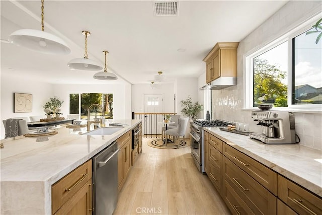 1909 Montair Ave, Long Beach, CA 90815 - kitchen featuring appliances with stainless steel finishes, a sink, light wood finished floors, and light stone counters