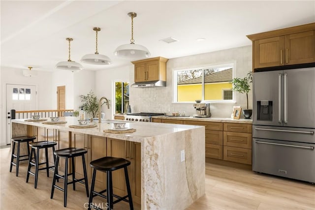 1909 Montair Ave, Long Beach, CA 90815 - kitchen featuring high end fridge, light wood-type flooring, decorative backsplash, light stone counters, and recessed lighting