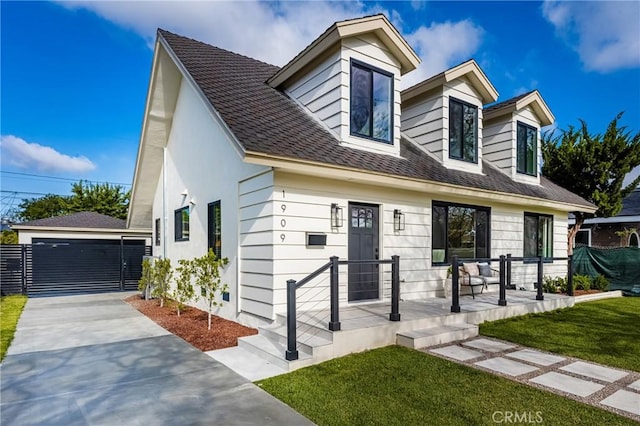 1909 Montair Ave, Long Beach, CA 90815 - view of front of house featuring an outdoor structure, a front lawn, and a detached garage