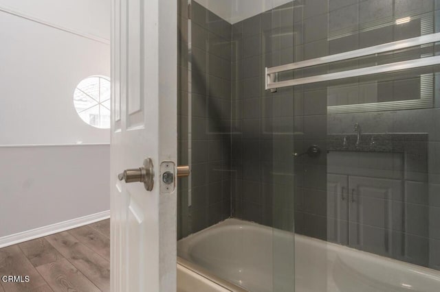 9216 Tobias Ave Unit 22, Panorama City, CA 91402 - full bath featuring wood finished floors, baseboards, and washtub / shower combination