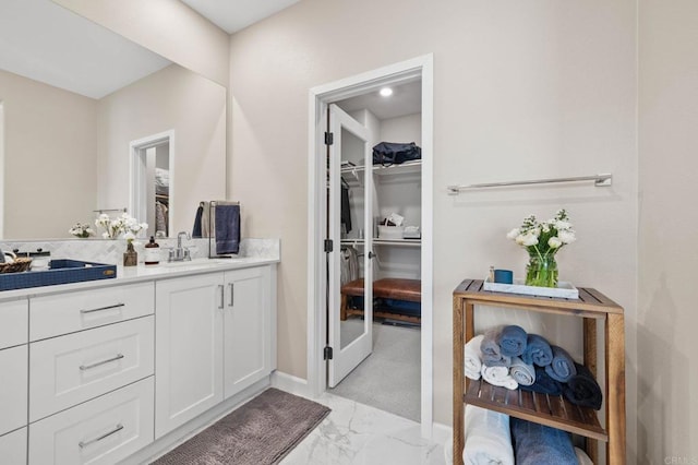 1211 Sunrise Vw Unit 104, San Marcos, CA 92078 - full bath featuring marble finish floors, a walk in closet, vanity, and baseboards