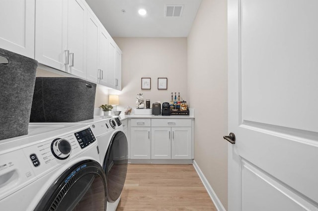 1211 Sunrise Vw Unit 104, San Marcos, CA 92078 - washroom featuring separate washer and dryer, cabinet space, light wood finished floors, and baseboards