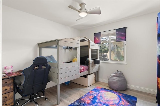 bedroom featuring wood finished floors, baseboards, and ceiling fan
