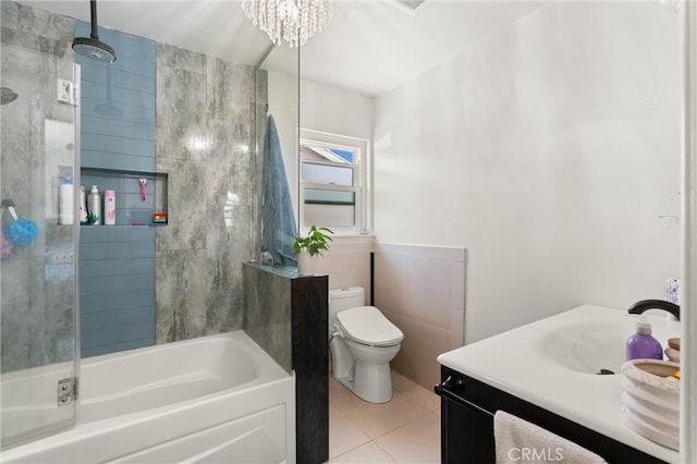 full bathroom featuring toilet, tile patterned floors, vanity, a combined bath / shower with rainfall shower, and tile walls