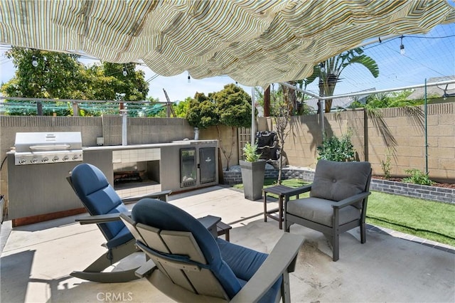 view of patio / terrace featuring area for grilling and a fenced backyard