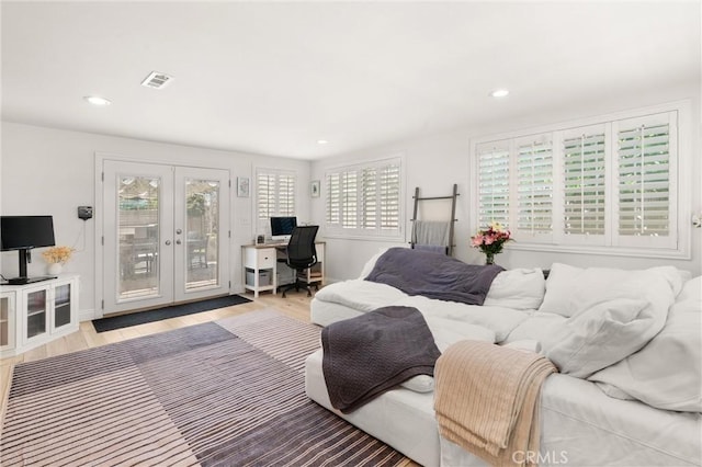 bedroom with access to exterior, french doors, an office area, wood finished floors, and recessed lighting