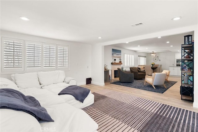 living area featuring wood finished floors, recessed lighting, and baseboards