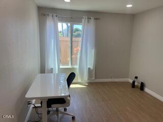 office space featuring baseboards, recessed lighting, and wood finished floors