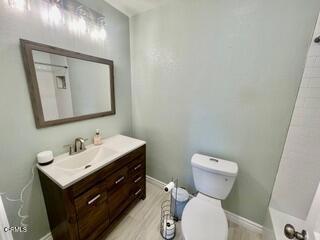257 W Channel Islands Blvd, Port Hueneme, CA 93041 - bathroom featuring vanity, wood finished floors, a shower, and a tub