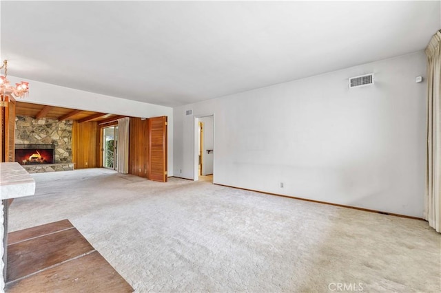 926 E Dalton Ave, Glendora, CA 91741 - unfurnished living room featuring light carpet, a stone fireplace, and baseboards