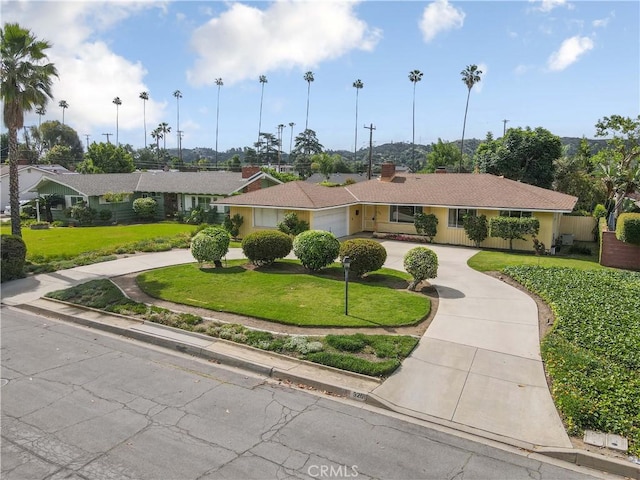 926 E Dalton Ave, Glendora, CA 91741 - view of front of house with curved driveway, a front yard, and an attached garage