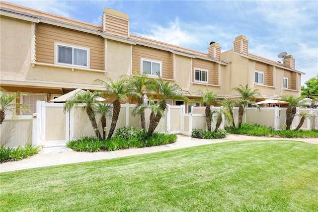 290 Victoria St Unit 19, Costa Mesa, CA 92627 - townhome / multi-family property with a gate, a chimney, and stucco siding