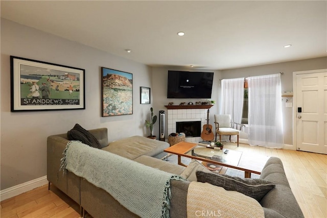 290 Victoria St Unit 19, Costa Mesa, CA 92627 - living room with light wood-type flooring, baseboards, a tile fireplace, and recessed lighting