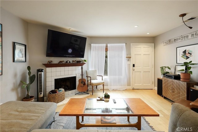 290 Victoria St Unit 19, Costa Mesa, CA 92627 - living room featuring a tiled fireplace, wood finished floors, and recessed lighting