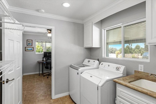 clothes washing area with separate washer and dryer, cabinet space, crown molding, a desk, and baseboards
