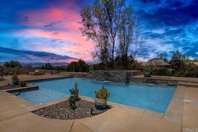 view of pool featuring a patio and a pool with connected hot tub