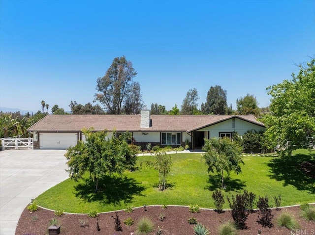 ranch-style home featuring driveway, an attached garage, and a chimney