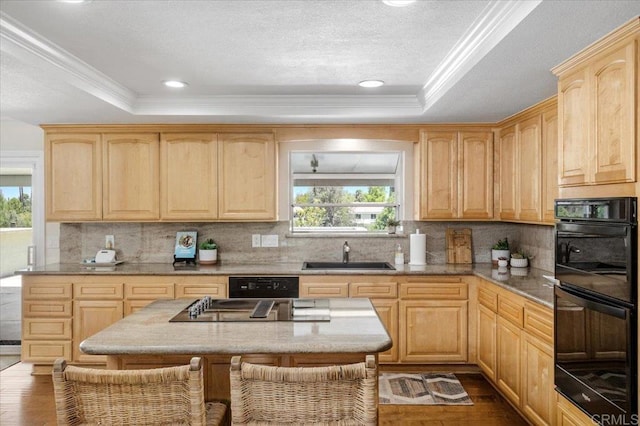 kitchen featuring a sink, black appliances, light brown cabinets, a raised ceiling, and crown molding