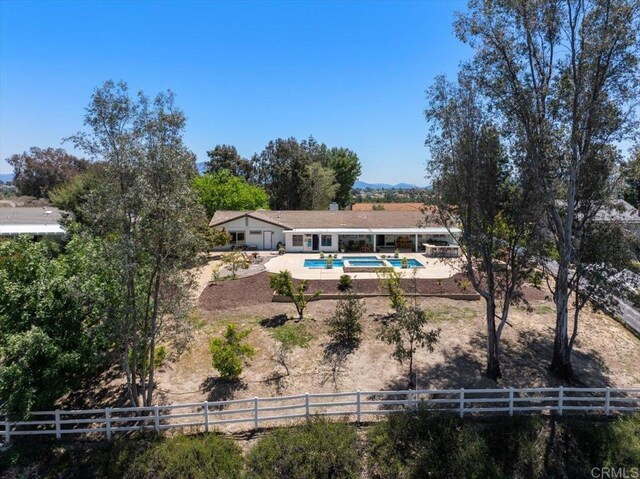 rear view of house with a patio area and fence