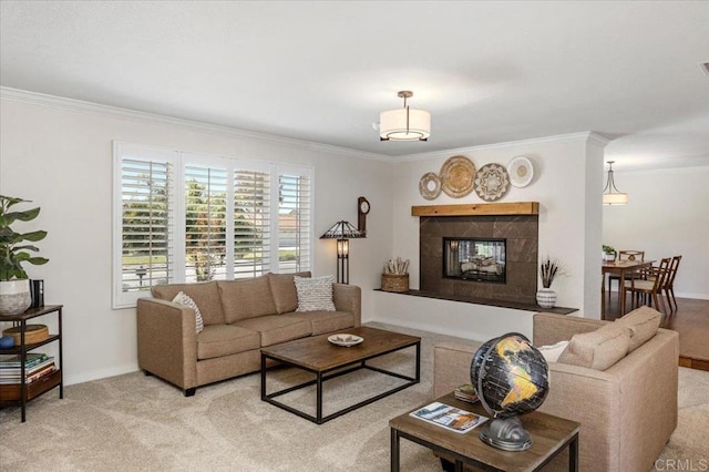 living room featuring crown molding, a tiled fireplace, light carpet, and baseboards