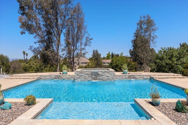 outdoor pool featuring an in-ground hot tub