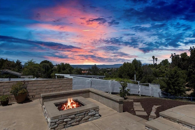 view of patio / terrace featuring an outdoor fire pit and fence