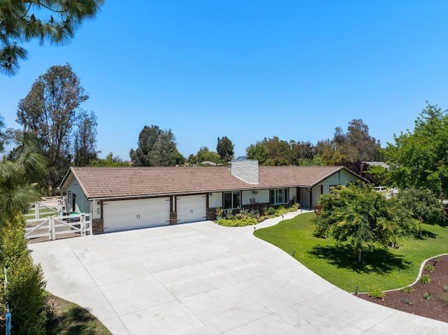single story home featuring an attached garage, driveway, and a gate