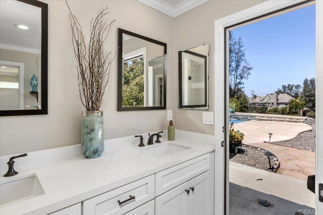 full bath featuring crown molding and double vanity