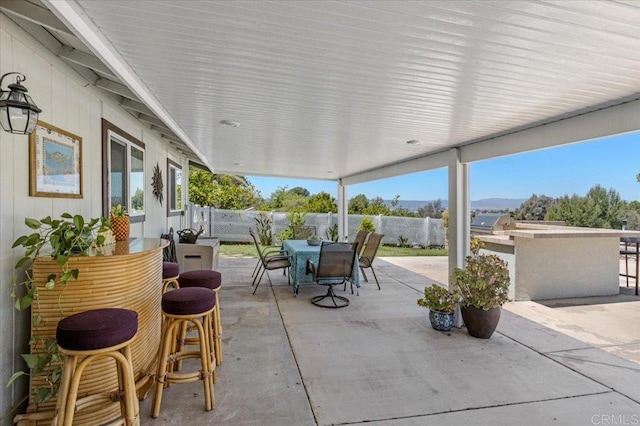 view of patio with a fenced backyard and outdoor dining area