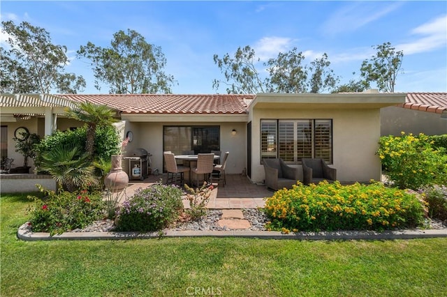 77178 Pauma Valley Way, Palm Desert, CA 92211 - back of house featuring a tile roof, stucco siding, a patio area, and a lawn
